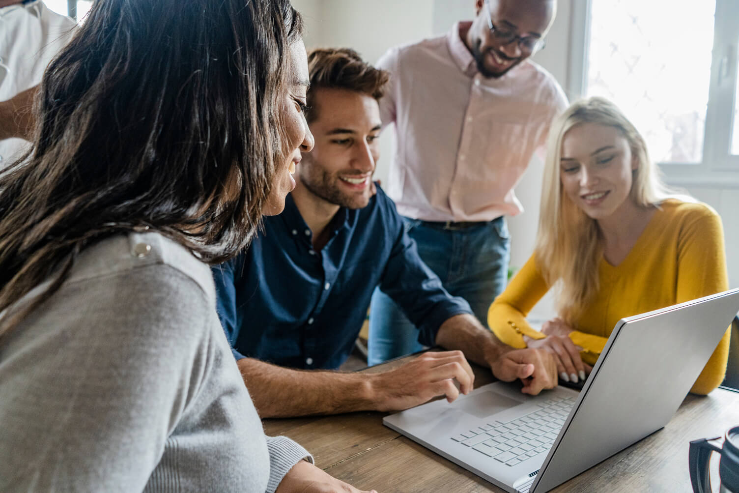 group of employees joined to look at computer screen