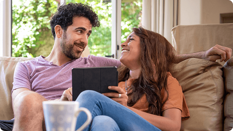 couple on couch smiling