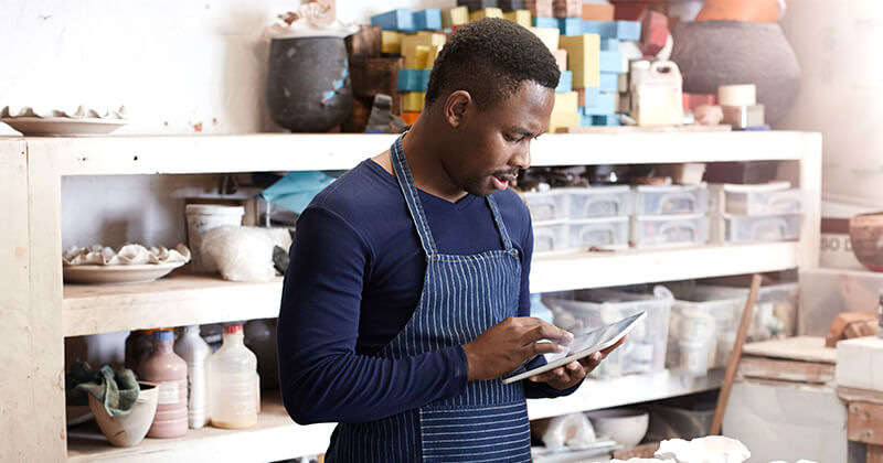 Man using using tablet in creative studio