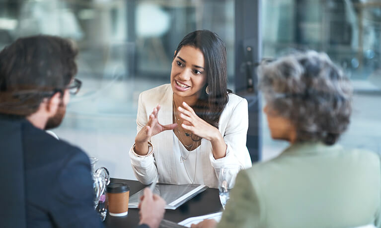 Businesswoman speaking to colleagues 