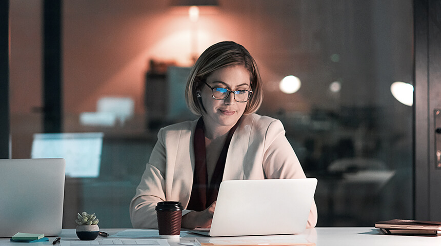 woman working on her laptop in the office at night