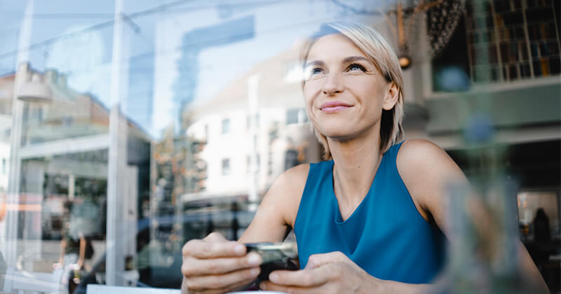 business woman looking out a window while taking a break