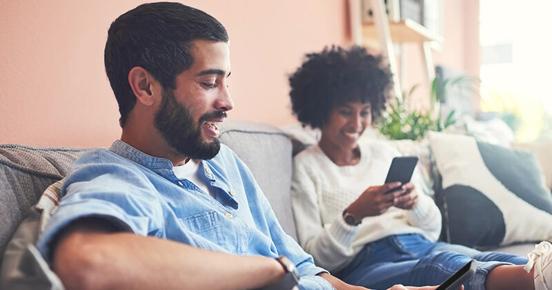 couple using phone at home