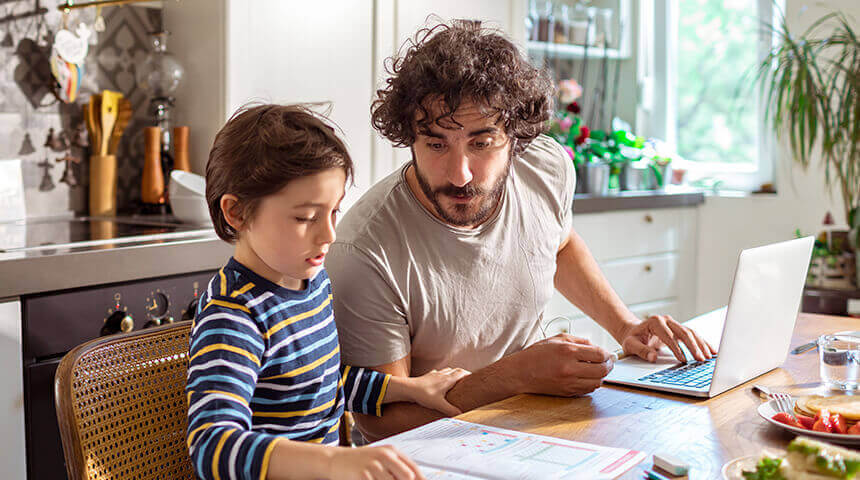 Father helping son with schoolwork