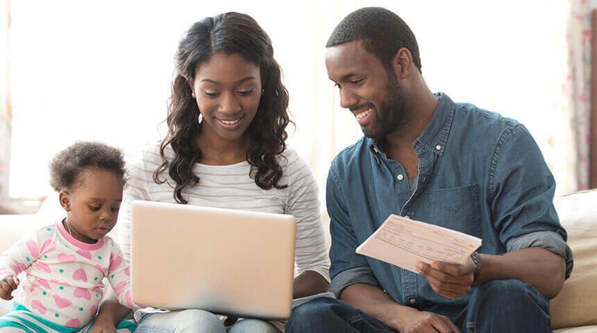 Parents paying bills on laptop