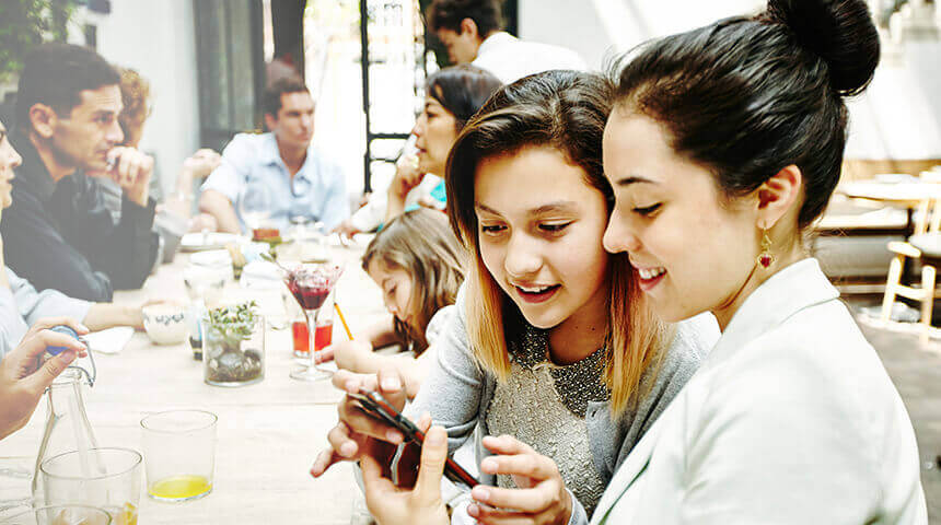 sisters looking at smartphone