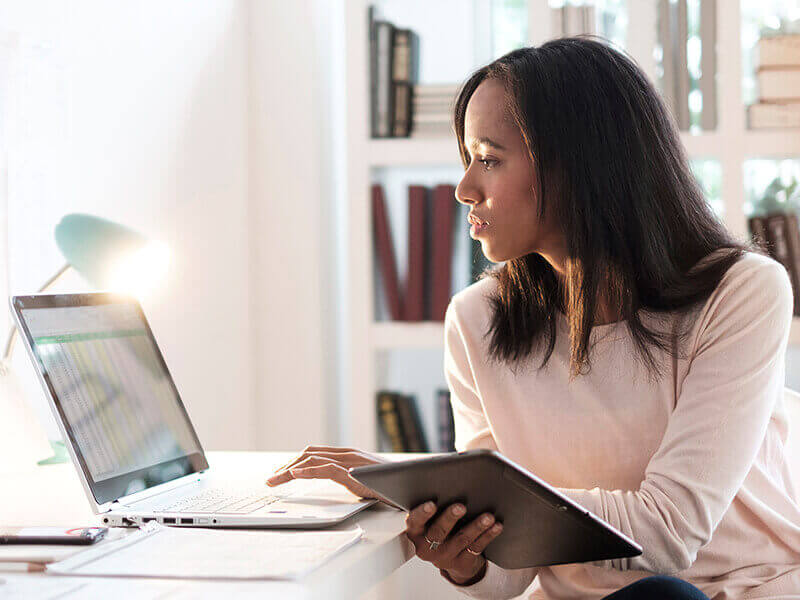 Woman using laptop and ipad