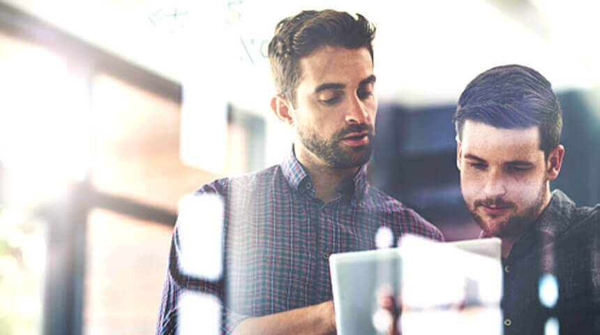 two men working on analytics insights