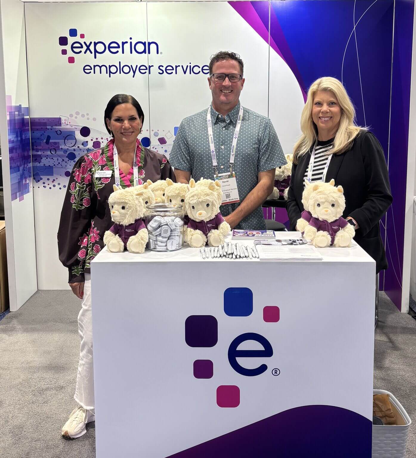3 attendees are at a booth for employer services at ashhra