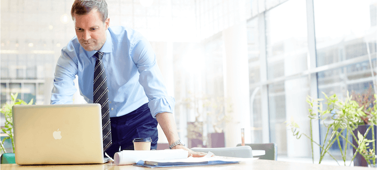 man looking at laptop in office