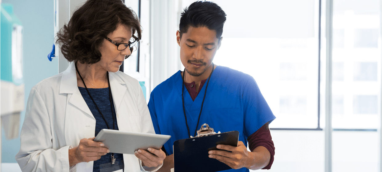 doctor and nurse looking at chart