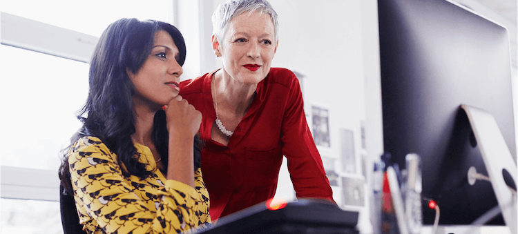 two women looking at computer screen