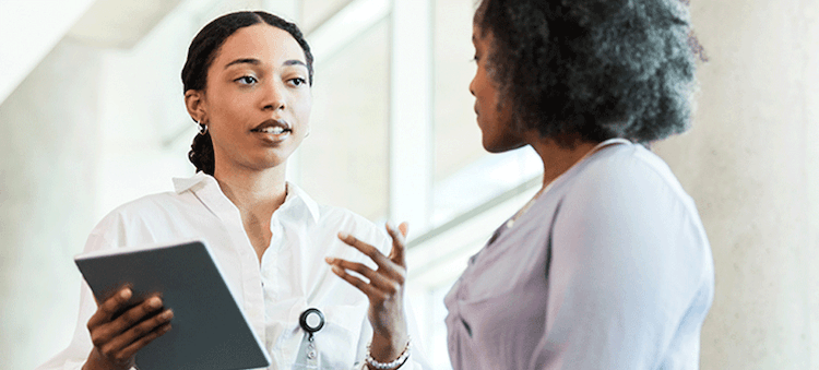 doctor talking to patient with tablet