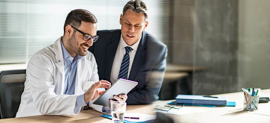 doctor and business man talking in office