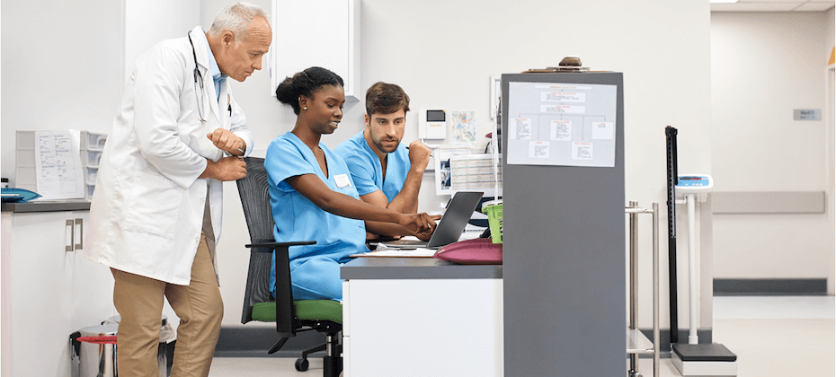 medical practitioners looking at a computer screen