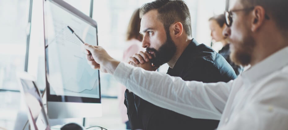 man-pointing-computer-screen